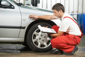 auto mechanic repairman inspecting car